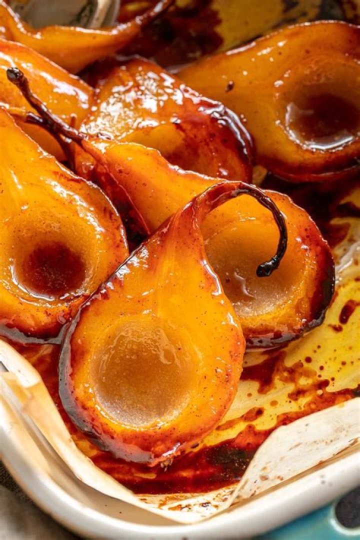 Pears in a baking dish topped with honey.
